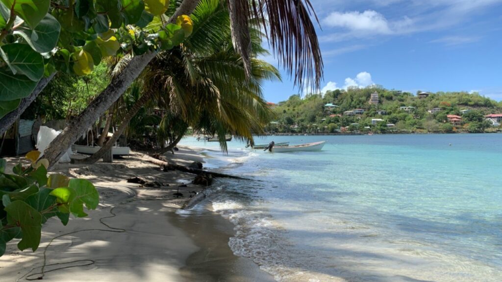 The beach of Laborie Bay with boats in the water in Saint Lucia