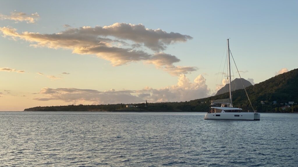Petit Trout anchorage at sunset with catamaran anchored